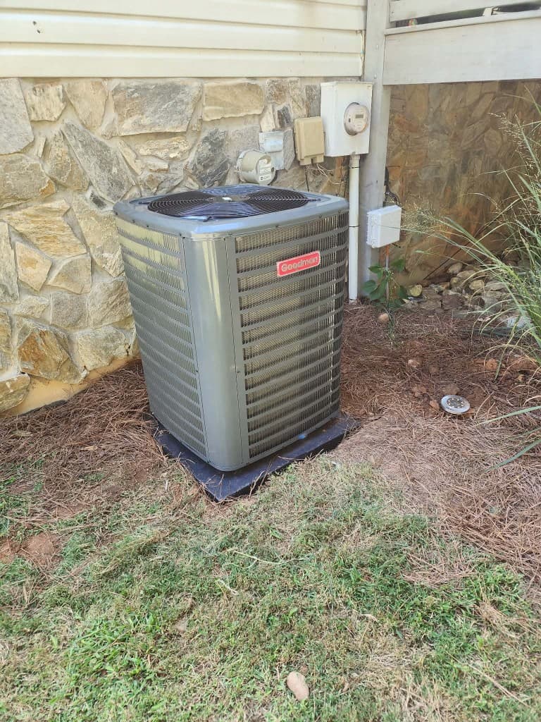 Goodman condenser — stone veneer home